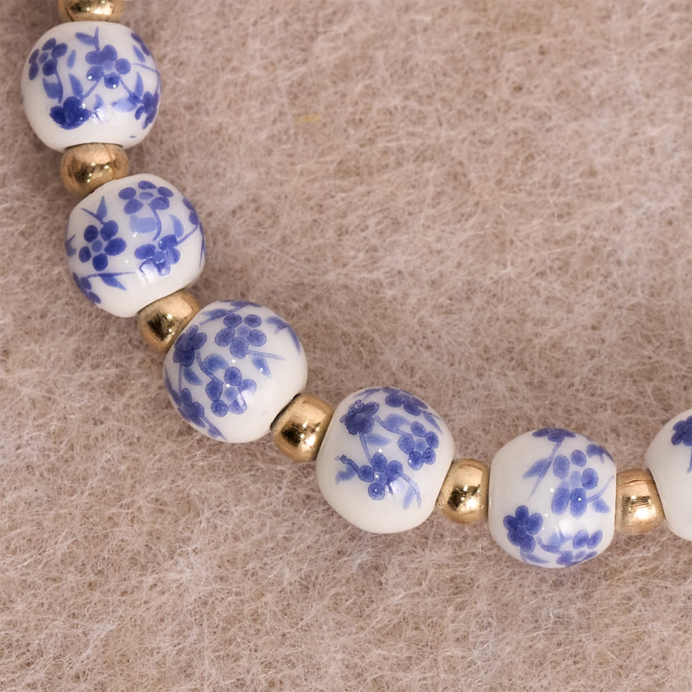 Blue/Pink Floral Ceramic Bead Bracelet with Large White Accent Bead: A Reminder of Divine Grace