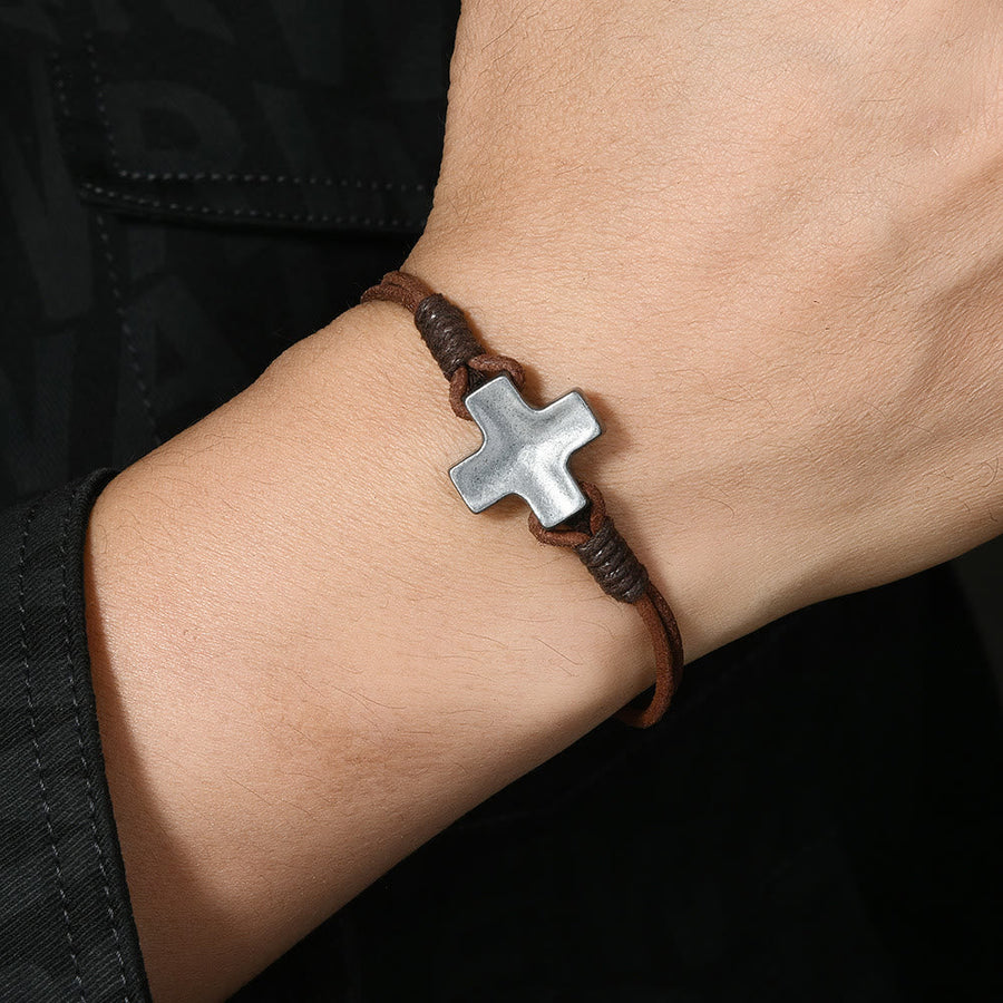 Antiqued Metal Cross on Braided Leather Cord: An Emblem of Steadfast Belief