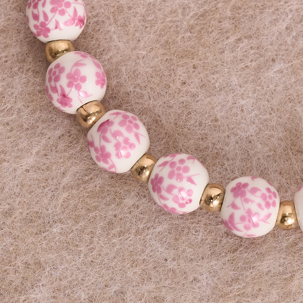 Blue/Pink Floral Ceramic Bead Bracelet with Large White Accent Bead: A Reminder of Divine Grace
