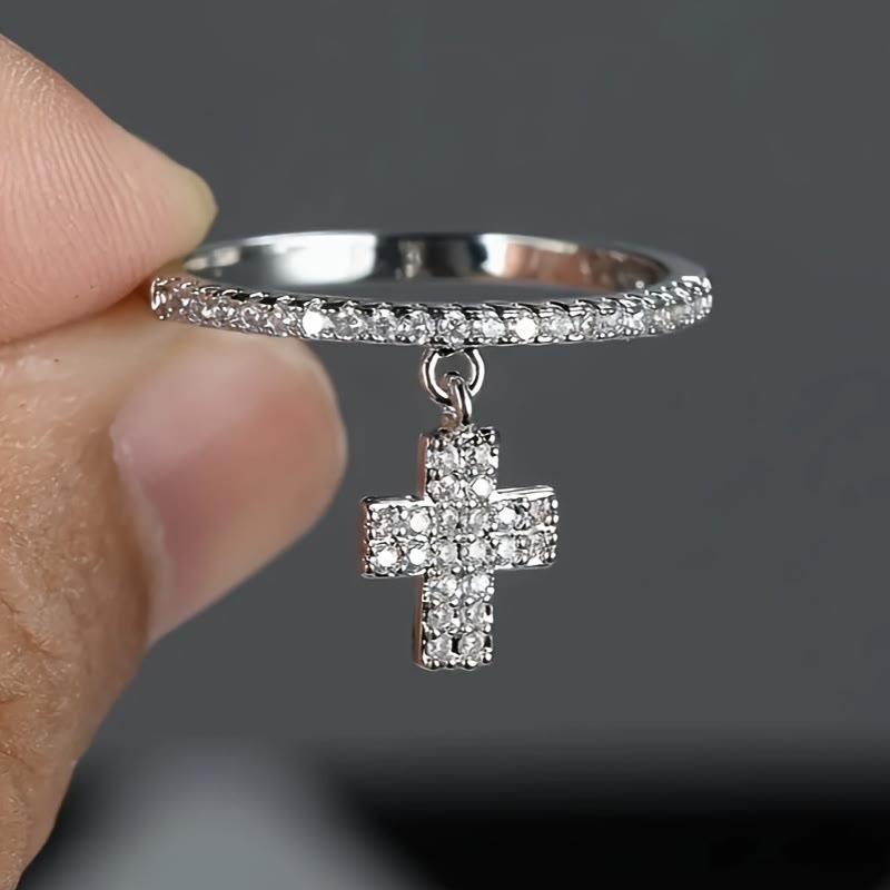 Eternity Band Cross Ring with Dangling Zirconia Cross Charm: A Reminder of Divine Light