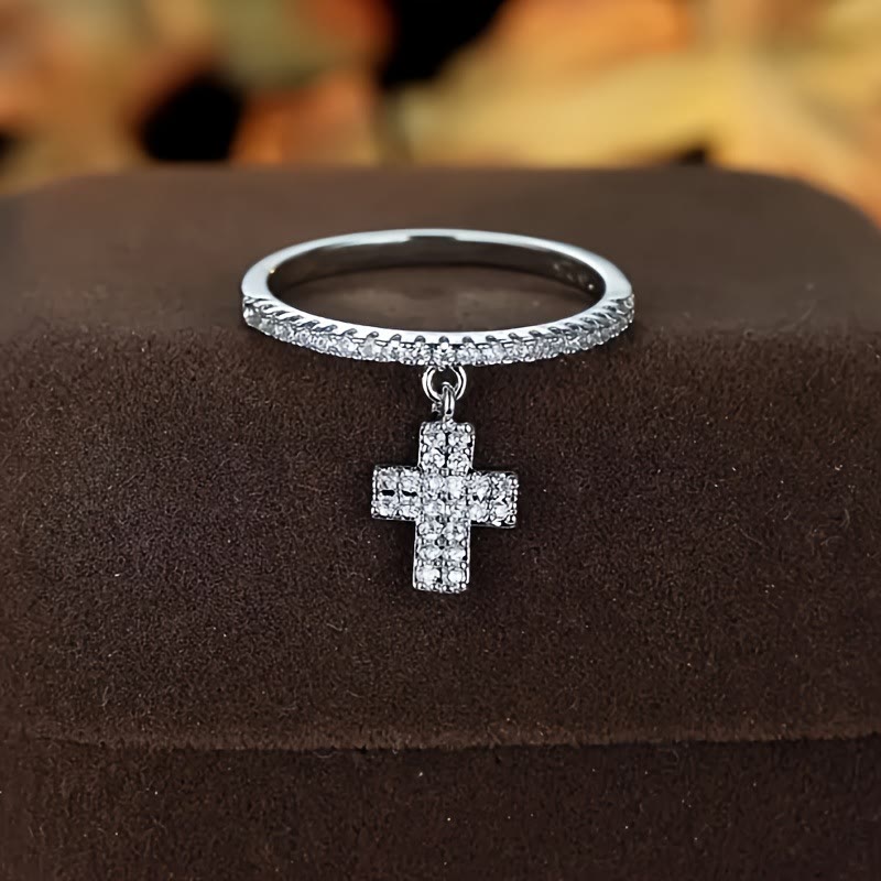 Eternity Band Cross Ring with Dangling Zirconia Cross Charm: A Reminder of Divine Light