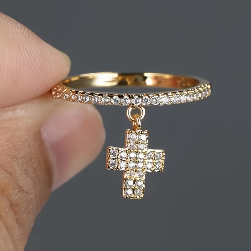 Eternity Band Cross Ring with Dangling Zirconia Cross Charm: A Reminder of Divine Light