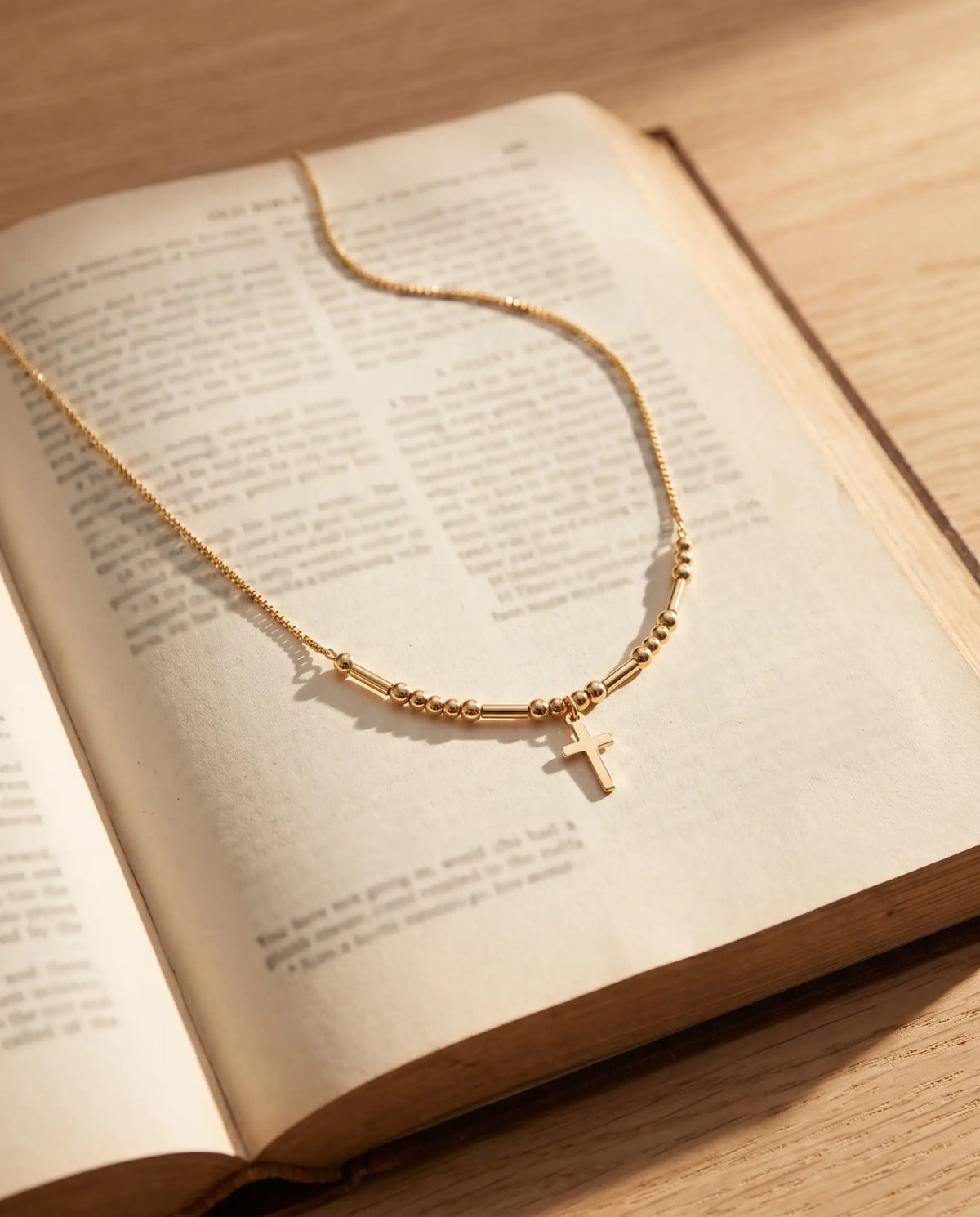 Hidden Prayer Morse Code Necklace laid across an open Bible
