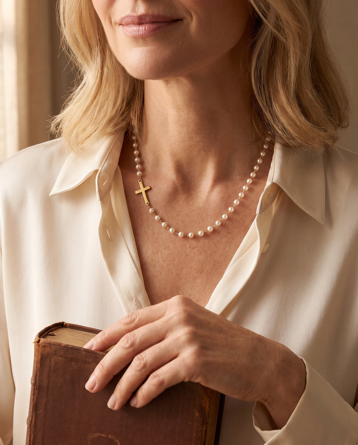 The Pearl of Great Price Cross Necklace worn with a Bible